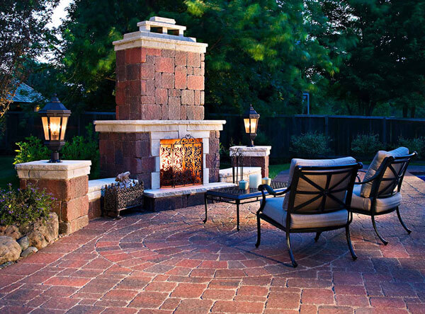 Outdoor fireplace with matching paving stones.
