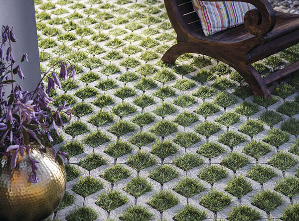 Grass pavers underneath a wooden chair.