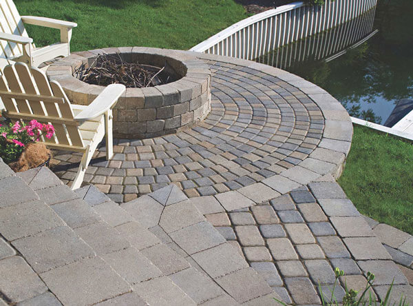 Patio fire pit with steps leading to water.