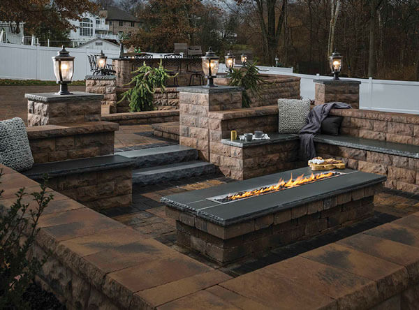 Pavers cover the entire landscape from walls to fire pit.