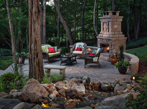 Woods patio area with seating and an outdoor fireplace.