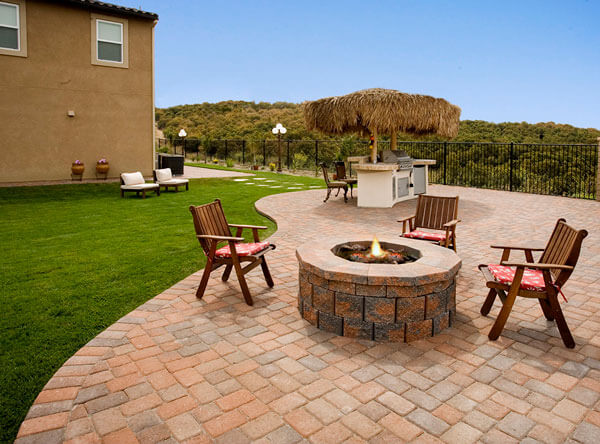 Tiki inspired patio with outdoor firepit and outdoor kitchen.