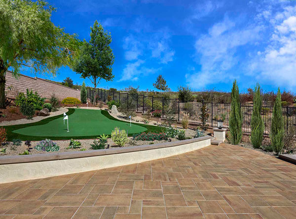 Backyard area with raised wall and putting green.