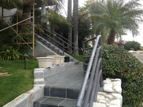 a metal railing in need of repair at a coastal San Diego home