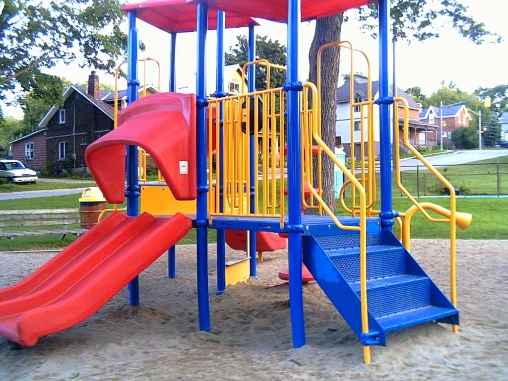 A playground with sand as the ground cover.