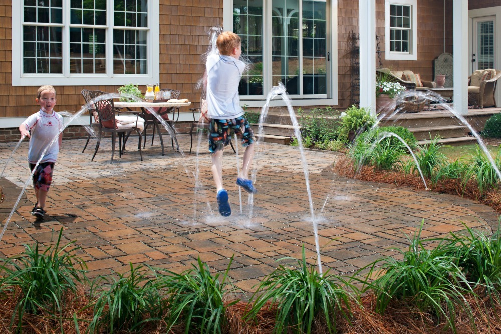 Kids' water play area with pavers