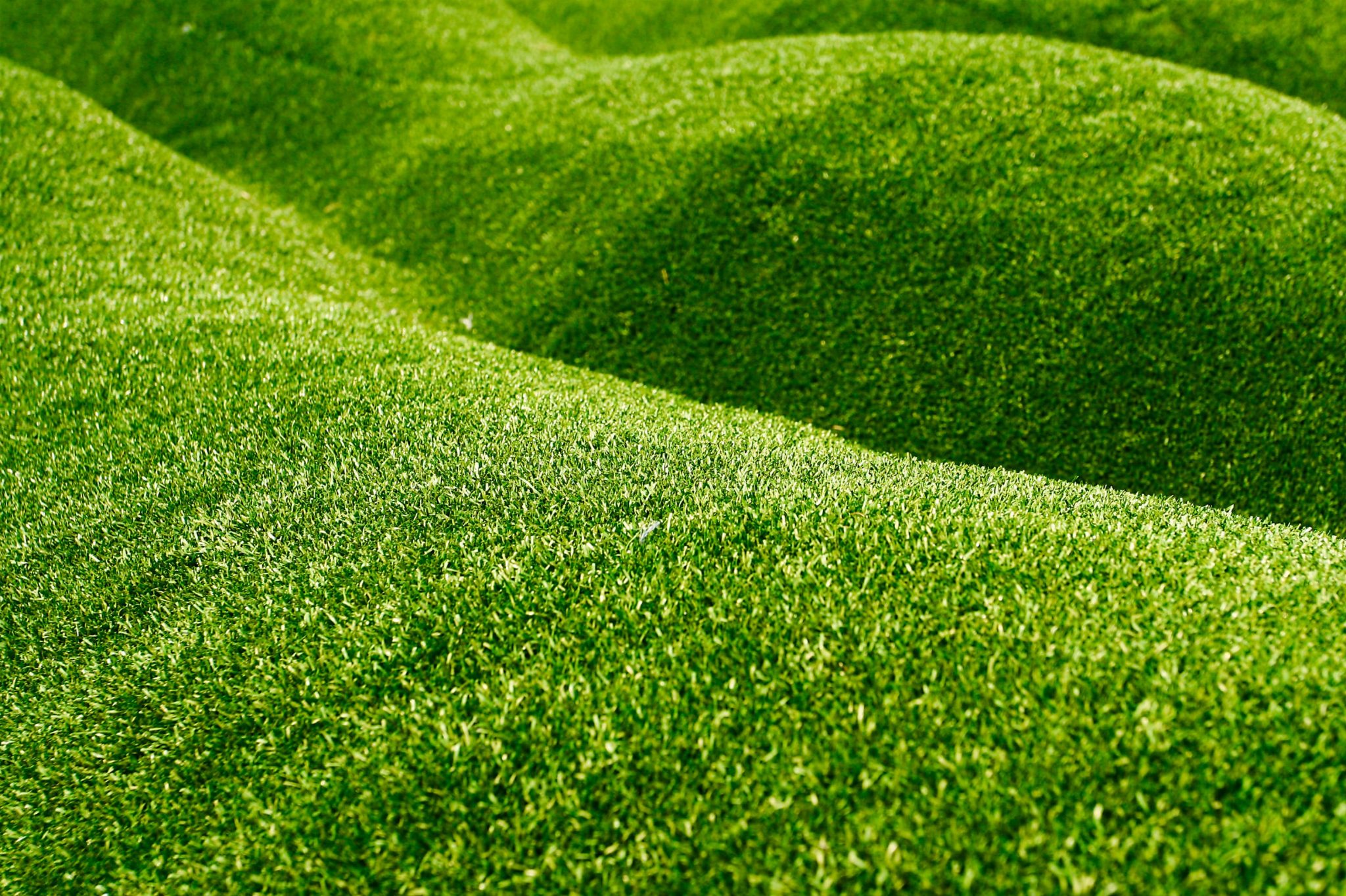can you put artificial grass on a slope