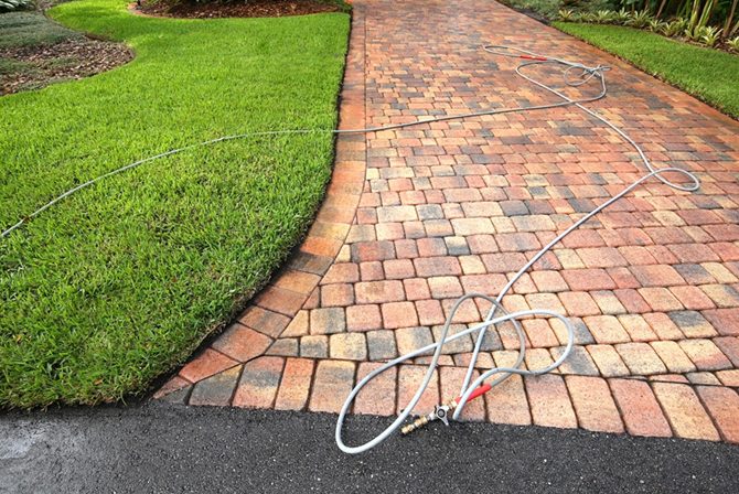 Pavers being professionally cleaned and sealed.