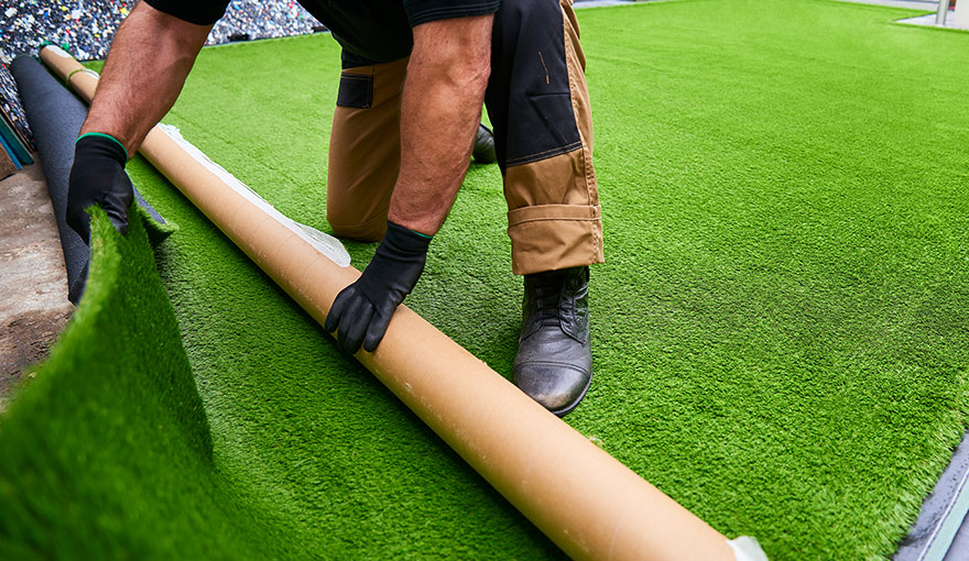Person installing artificial grass