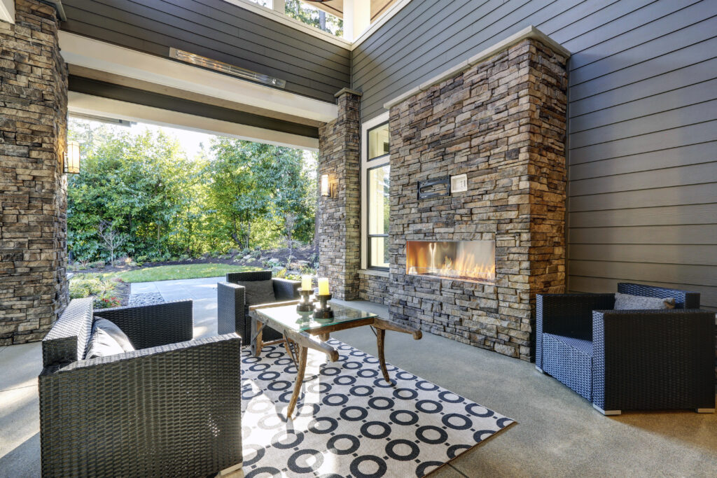 Outdoor stone fireplace in a backyard home in Del Mar, California. 