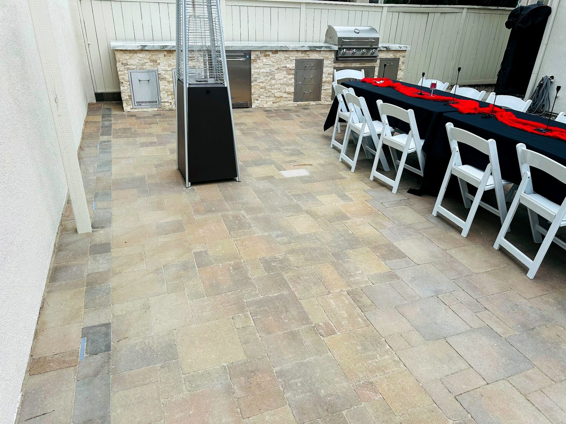 An outdoor kitchen in Carmel Valley — stone veneer, marble counter, eight appliances