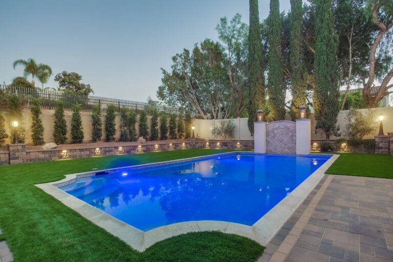 Twilight pool with blue lighting.