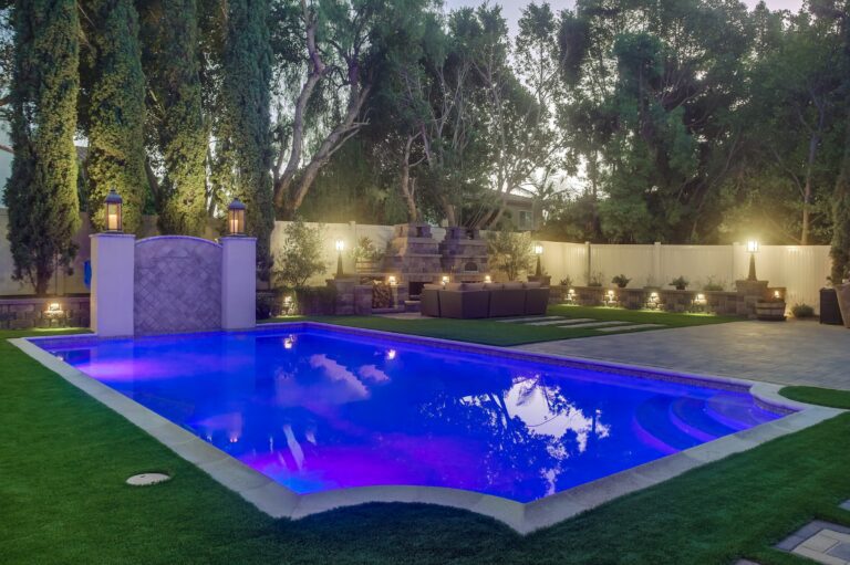 Close twilight pool with accent lighting.