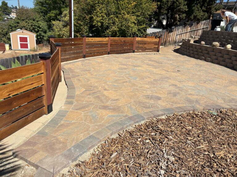 Completed curved patio using flagstone-style interlocking pavers with a contrasting soldier course border. El Cajon project by Install It Direct.