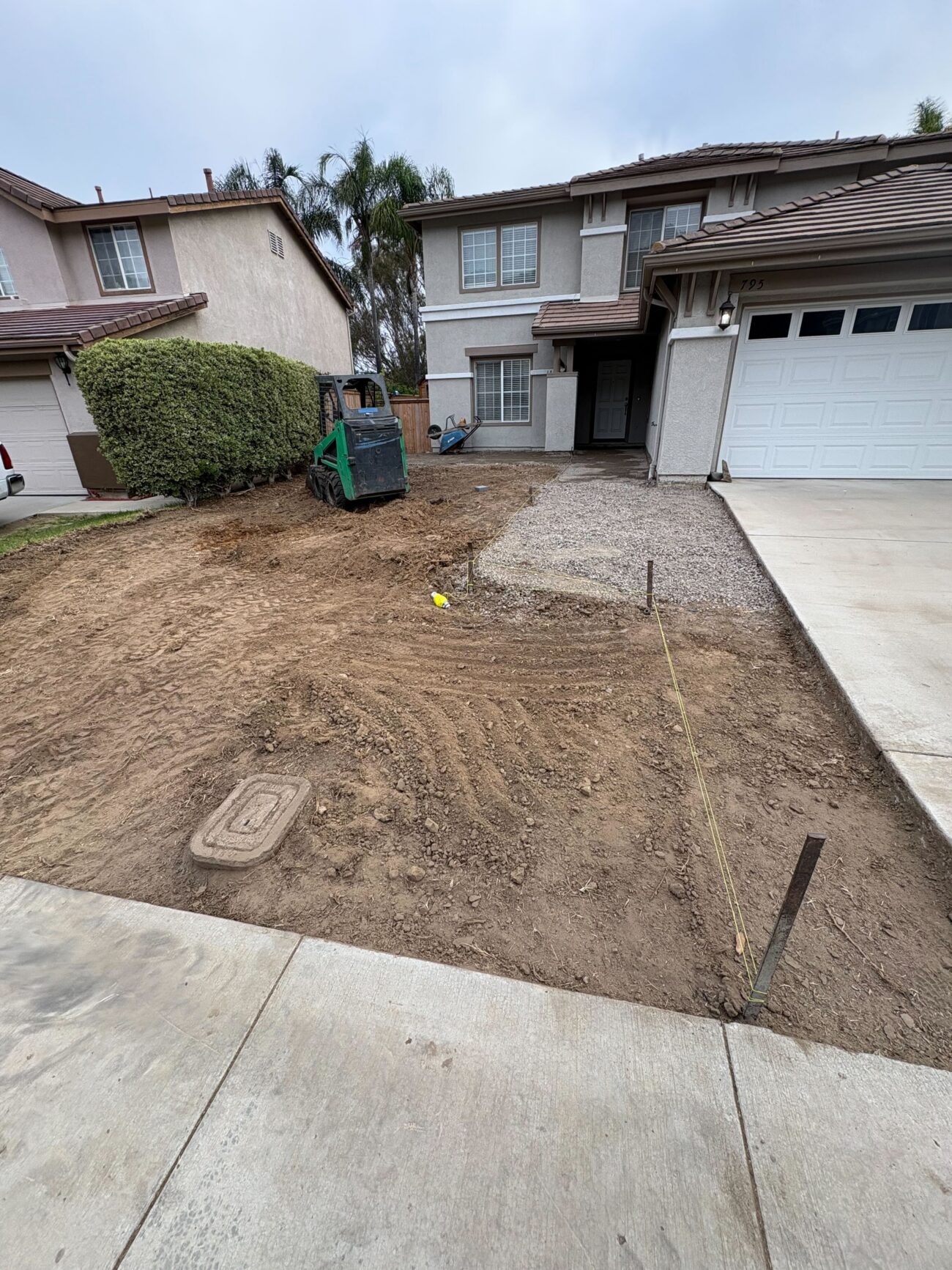 Front yard of a single-family home with existing sod removed and subgrade exposed. San Marcos project by Install It Direct.