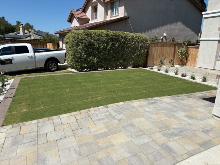 Residential front yard showing newly installed interlocking pavers in the foreground transitioning to a freshly laid artificial turf lawn with visible turf seams. San Marcos project by Install It Direct.