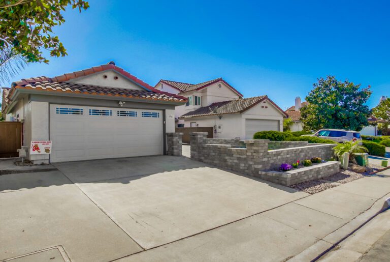 Completed backyard pavers, wall, and artificial turf in San Diego.