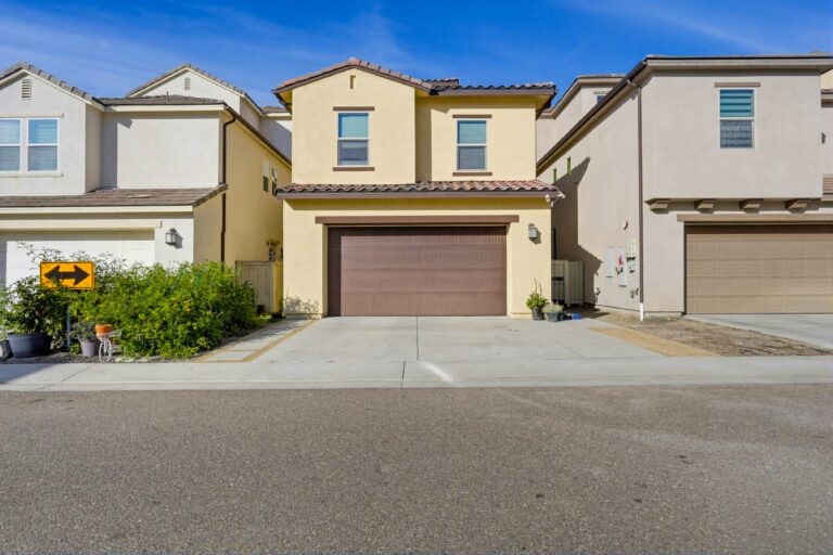 Walkway bordered by roses, block walls, and steps.