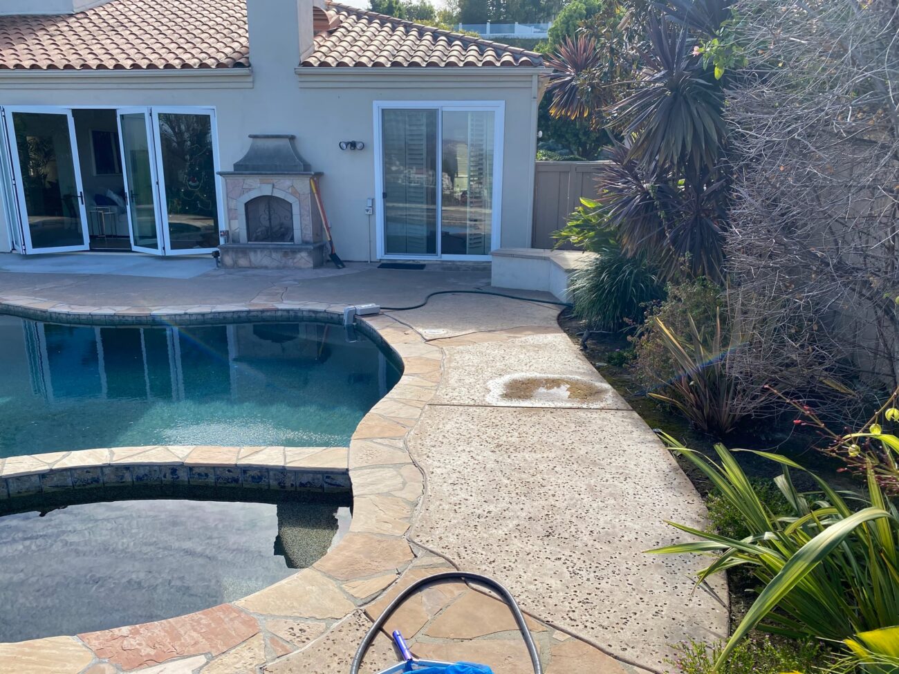 Before: weathered exposed-aggregate concrete pool deck in Carmel Valley, San Diego.