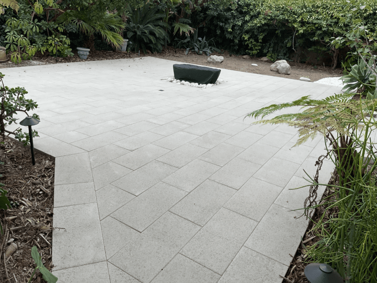 Completed backyard porcelain patio and retaining wall project in San Diego.