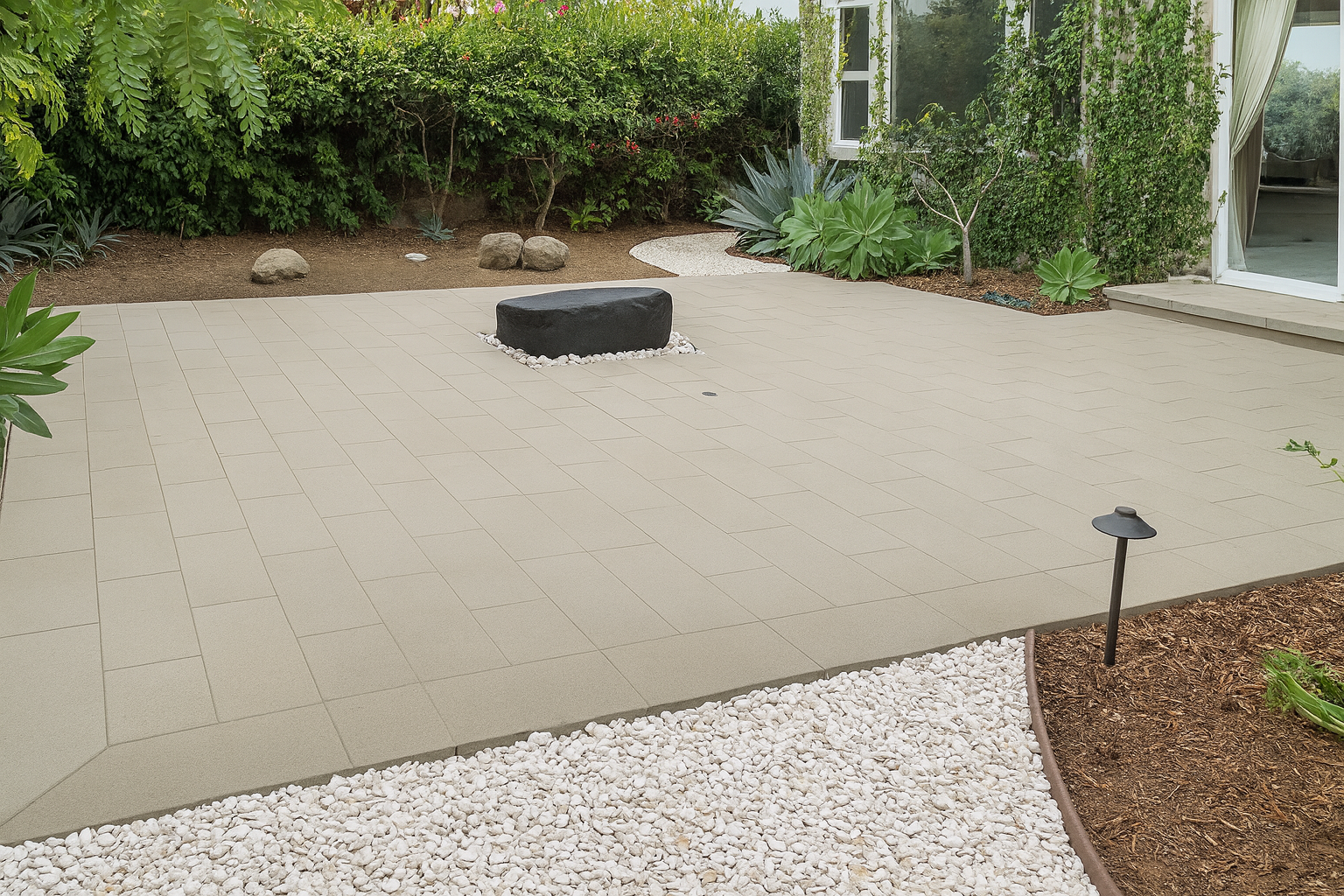 Completed backyard porcelain patio and retaining wall project in San Diego.