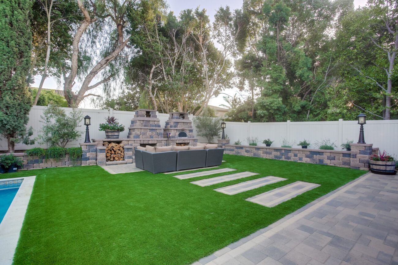 Angled lawn with pool and lounge.