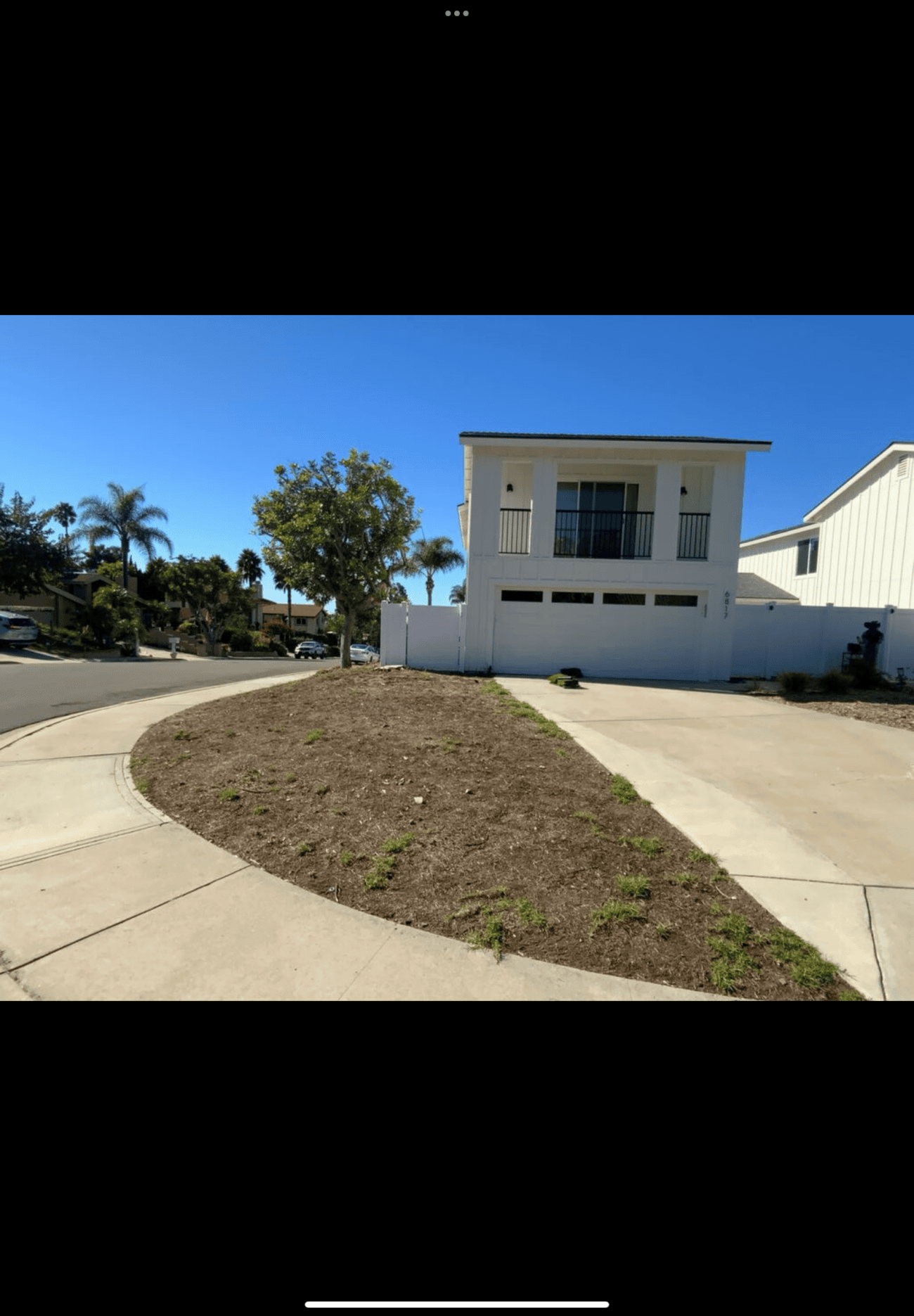 Before: the front-yard island was bare, compacted soil ringed by the home's circular driveway.