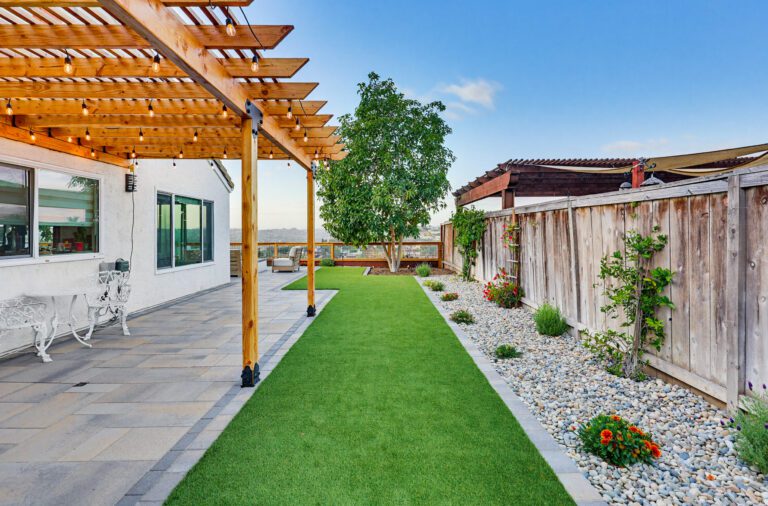 Completed paver patio, gas fire pit, artificial turf and outdoor kitchen at a Bonita home.