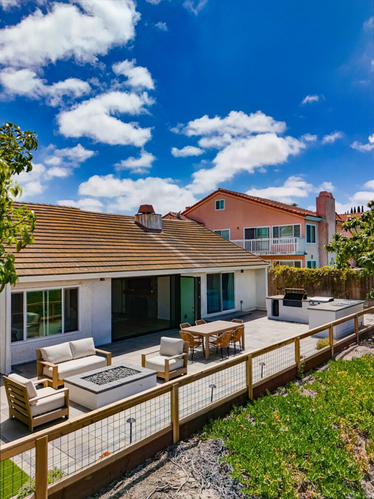 Establishing aerial: the paver terrace wraps the home beneath a wide valley backdrop