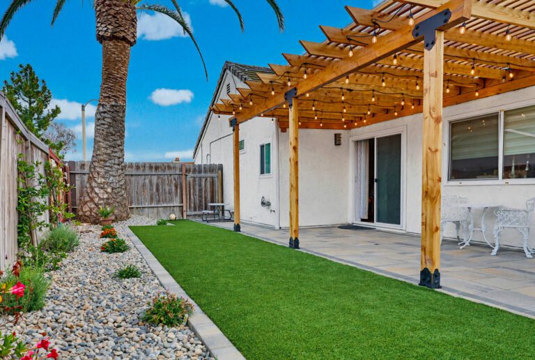 Completed paver patio, gas fire pit, artificial turf and outdoor kitchen at a Bonita home.