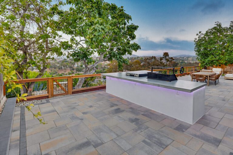 Outdoor kitchen island glows with LED accent lighting after sunset