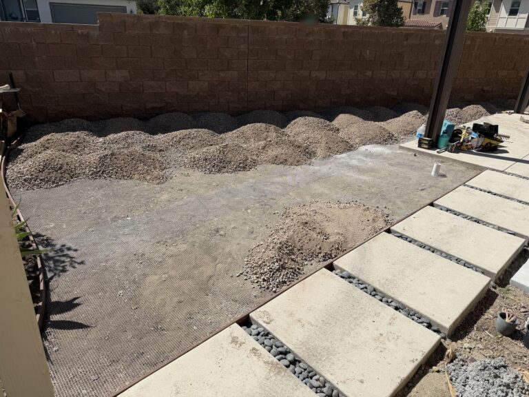 Gopher mesh laid across the lawn area with base rock piled for grading, before the turf went down, Escondido 92029