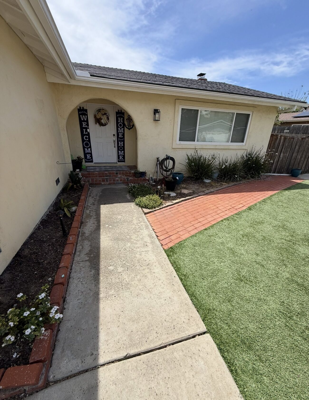 Before: a concrete walk with brick borders