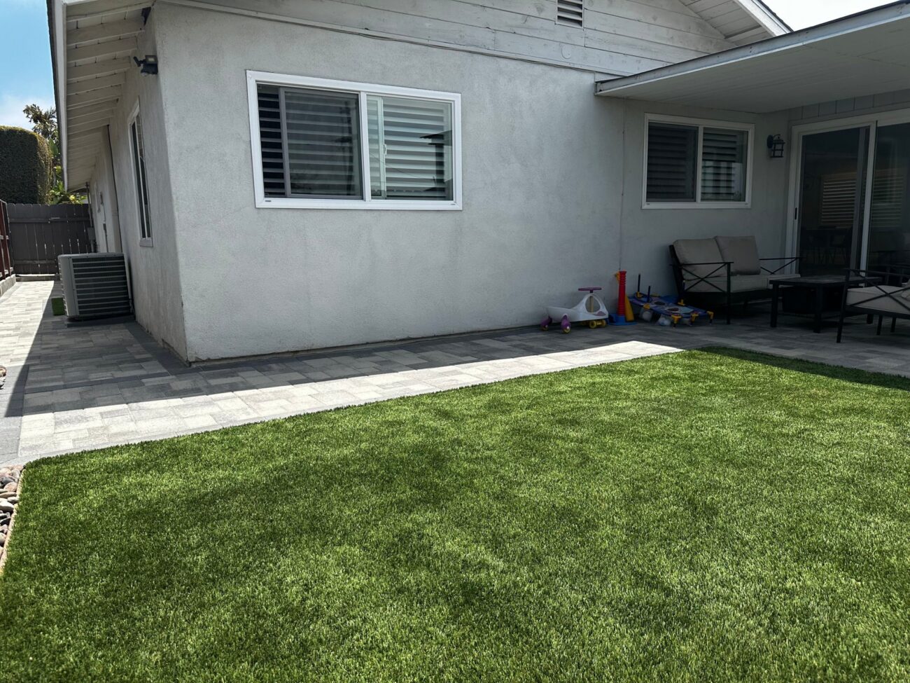 Pavers replaced the concrete strip along the back of the house