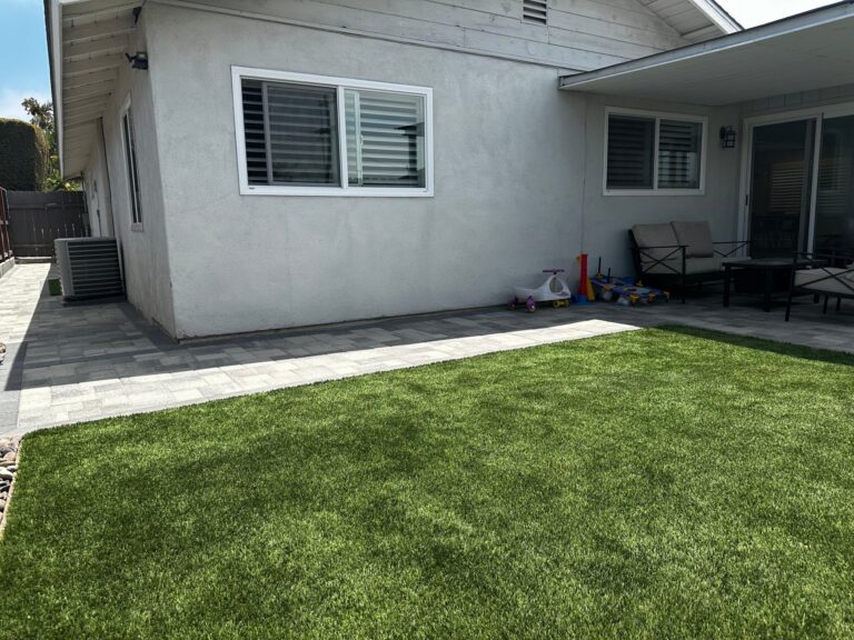 Pavers replaced the concrete strip along the back of the house