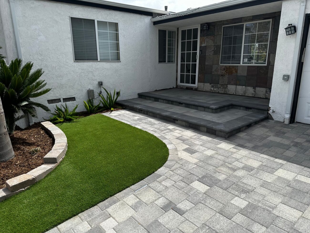 Paver steps finished with bullnose caps at the front entry