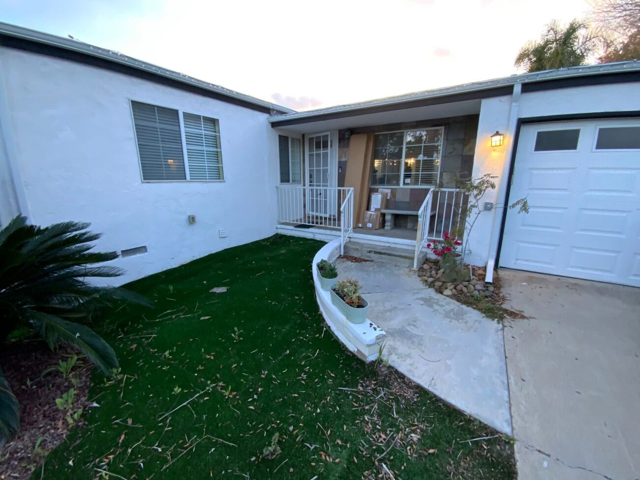 Before: a concrete walk with a painted planter edge