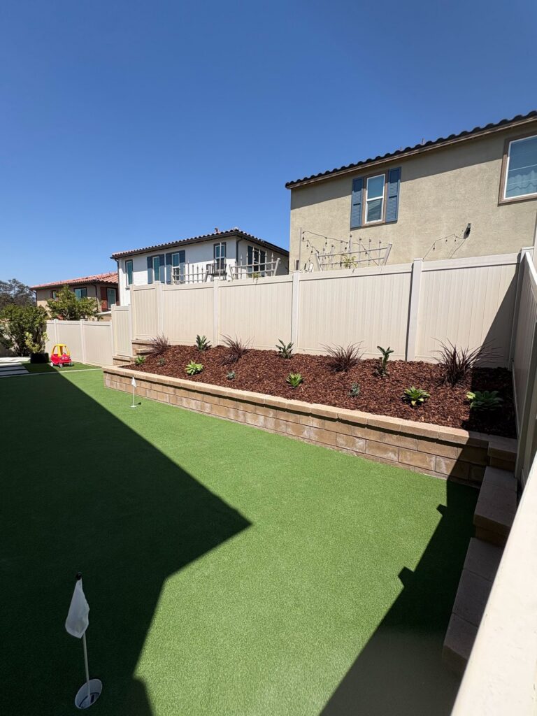 The side yard is now a putting green with three cups