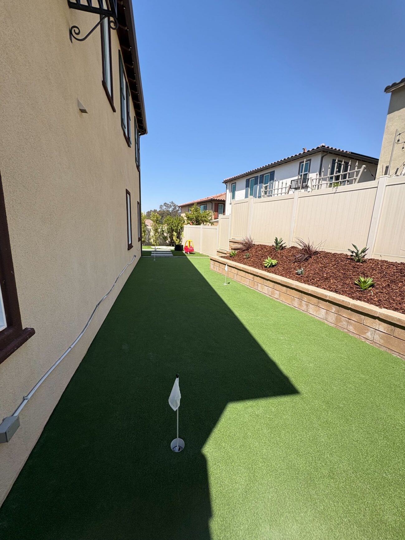 Looking down the putting green toward the back fence