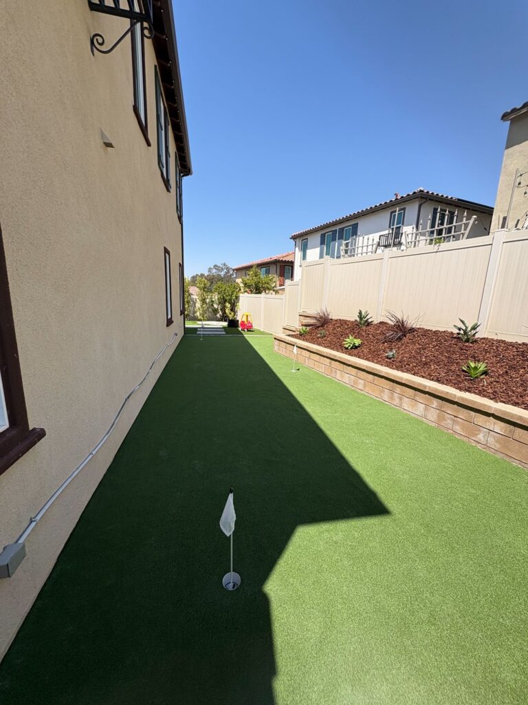Looking down the putting green toward the back fence