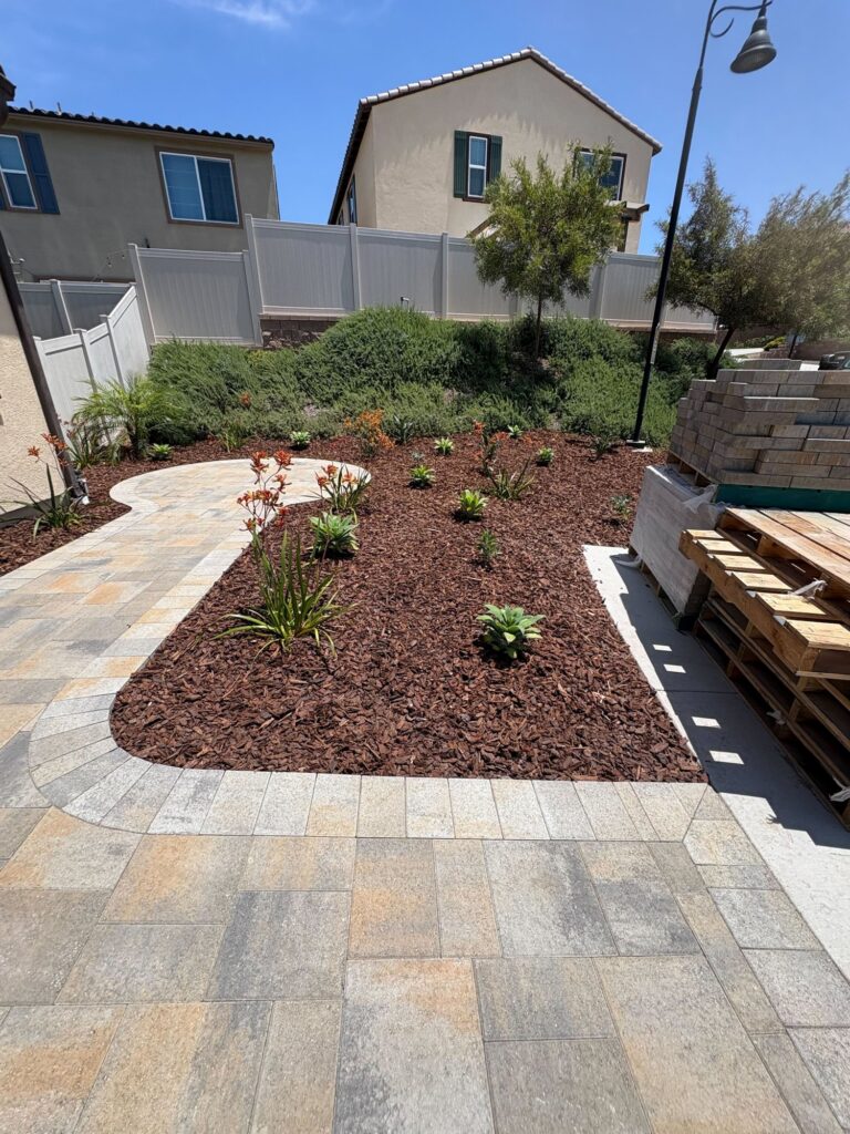 Belgard pavers curve through new planting and mulch