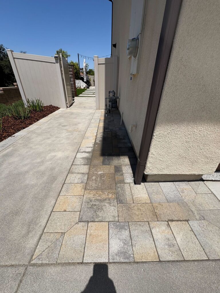 A paver path along the side of the house
